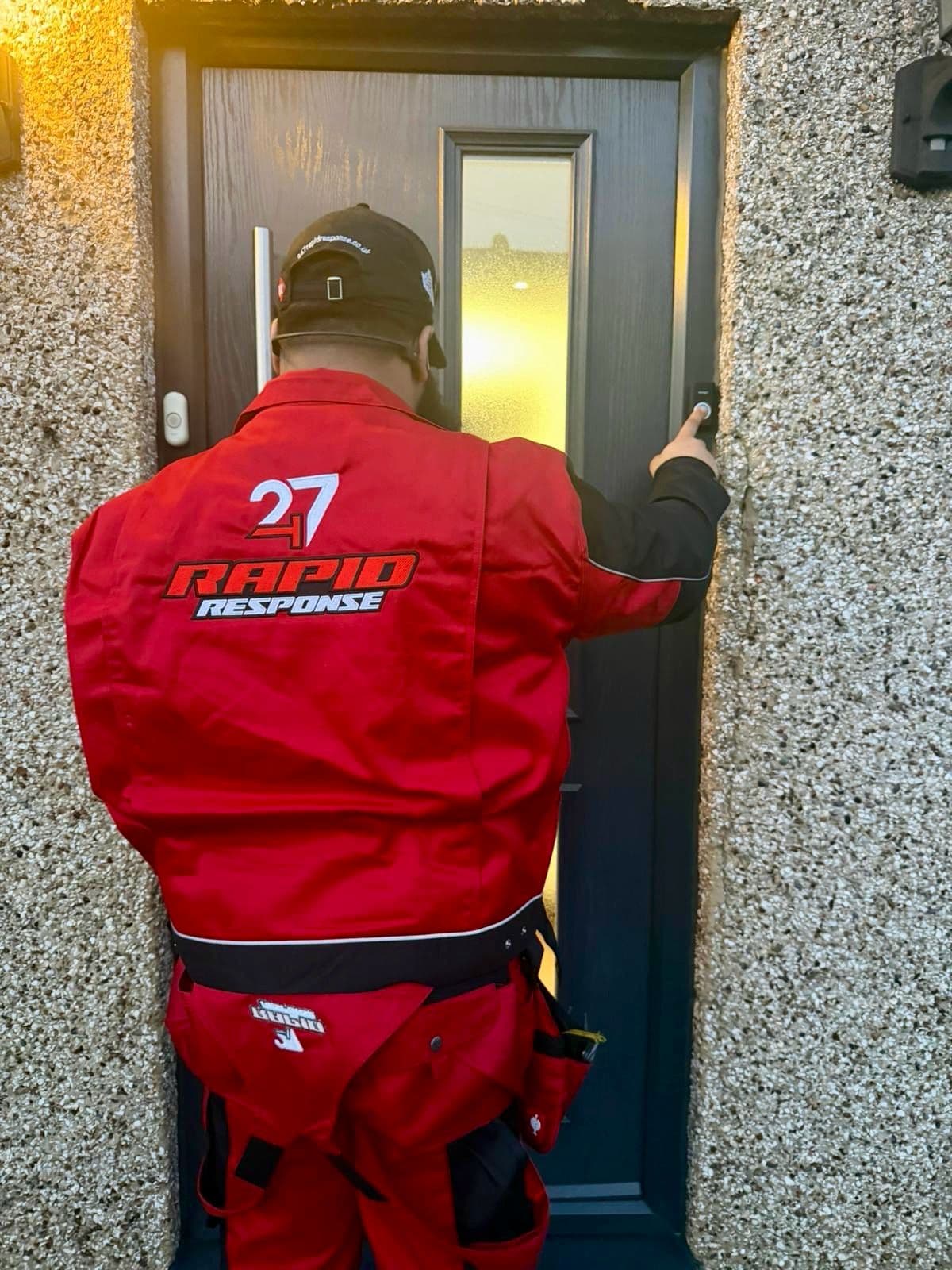 247 Rapid Response engineer ringing the bell at a London front door in branded red uniform, arriving on a callout